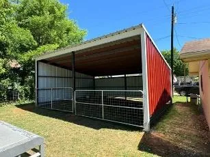Open-front metal livestock and equipment barn with pipe gates