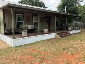 Manufactured home with covered porch and new white underpinning